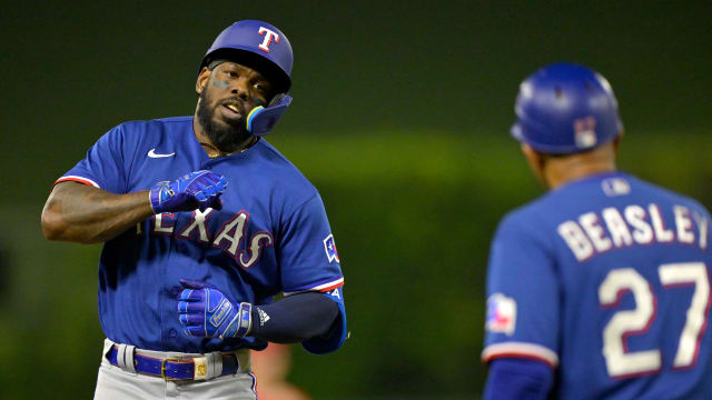 Texas Rangers right fielder Adolis Garcia taps his chest as he rounds third base after a solo home run in the third inning Wednesday against the Los Angeles Angels at Angel Stadium.